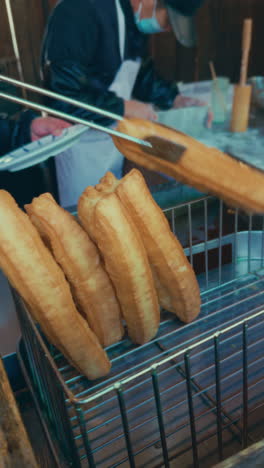 fried dough (youtiao) being prepared