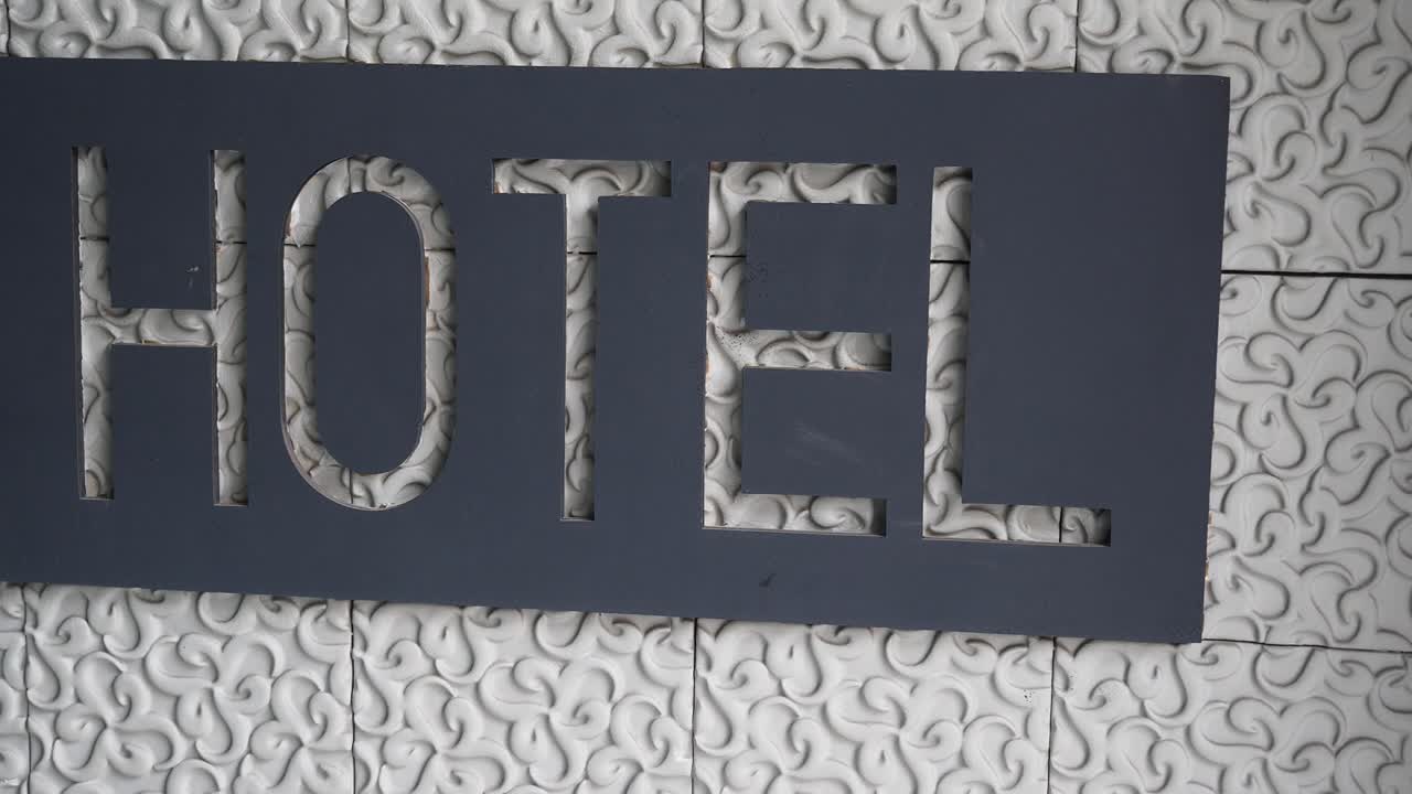 Hotel Sign on Textured Wall