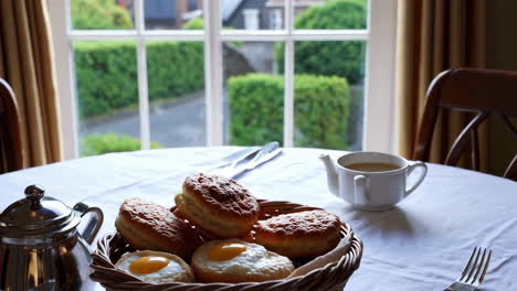 breakfast table with pastries and tea
