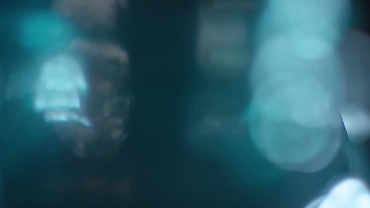 Abstract Teal and Blue Light Leaks with Bokeh Effect
