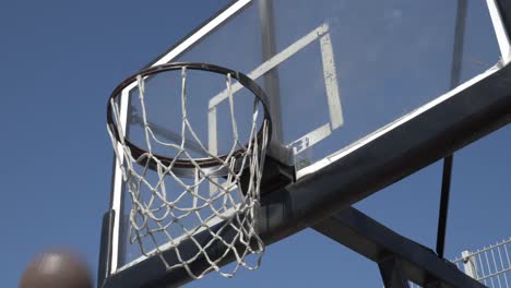 sunny basketball hoop overshoot in slow motion