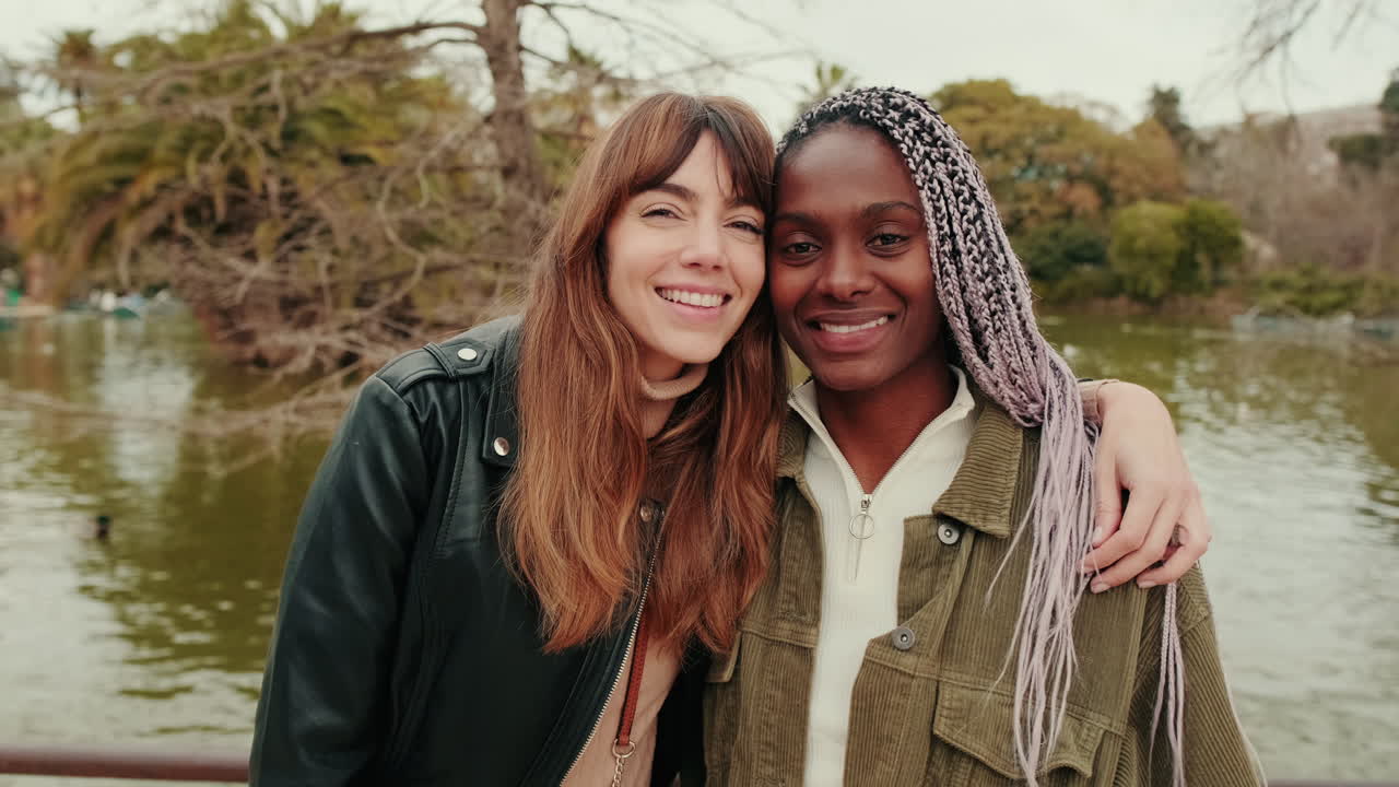 Happy Diverse Young Women Embracing and Smiling in a Park