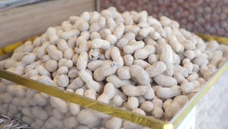 close up of shelled peanuts in a container