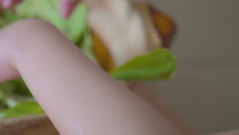 Close-up-of-young-girls-hands-washing-and-preparing-greens-for-eating-vegetables-in-the-kitchen