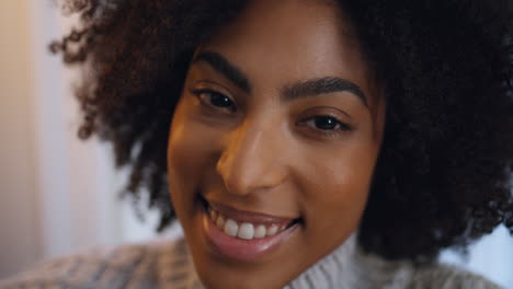 portrait curly model laughing indoors. brown eyes girl having fun looking camera