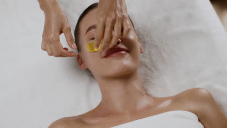 woman receiving gold mask facial treatment