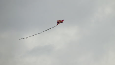 colorful kite in cloudy day with gray clouds