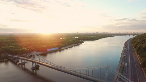 aerial landscape evening sunset over city. drone view hanging bridge over