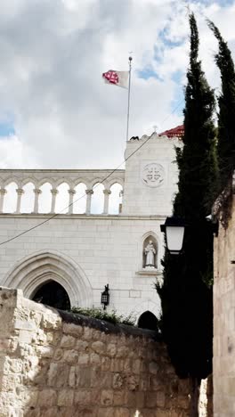dormition abbey with cross flag, jerusalem old city