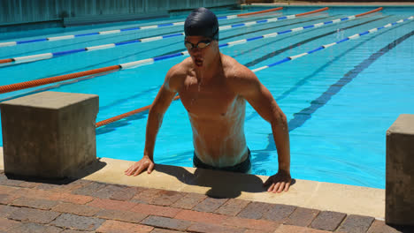 male swimmer getting out from pool 4k