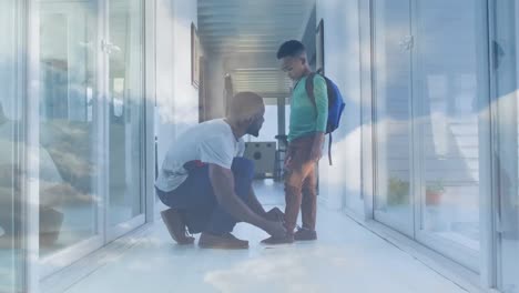 Animación-De-Luces-Sobre-Un-Feliz-Padre-Afroamericano-Atando-Un-Zapato-A-Su-Hijo