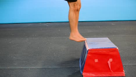 a still shot of a guy in a gymnastics gym doing from a