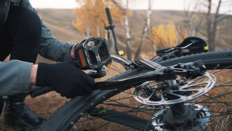 fixing the pedal of a mountain bike