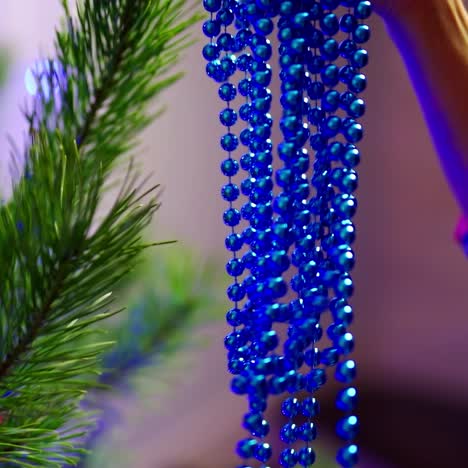 woman hands decorating christmas tree