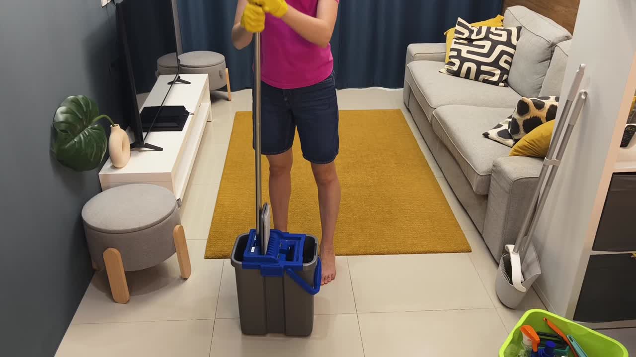 Woman mopping the floor at home
