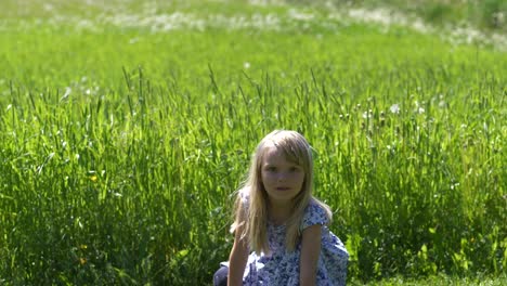 Lange-Aufnahme-Eines-Vierjährigen-Mädchens,-Das-Direkt-In-Die-Kamera-Starrt-Und-Im-Sommer-Im-Freien-Spielt