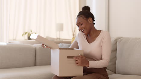 woman excitedly unboxing a gift or moving supplies