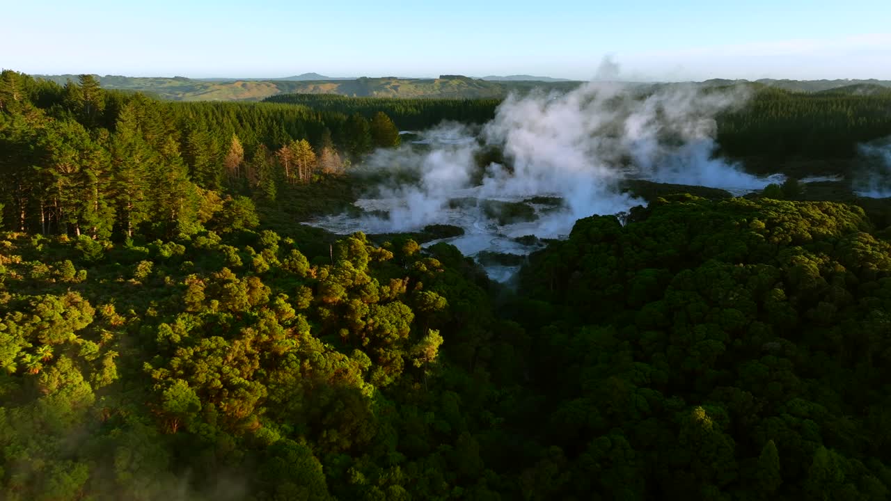 Wide high angle, Drone slowly flying over geothermal landscape. Trees, steam, bubbling mud and steam. Alien Landscape. Sci-fi. Global Warming