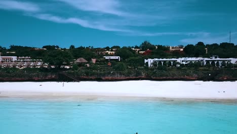 Perfect-aerial-flight-fly-backwards-drone-shot-of-a-luxury-resort-hotel-on-a-scenic-tropical-island-in-on-zanzibar,-africa-tanzania-2019