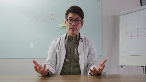 Portrait-of-asian-doctor-talking-on-video-call-looking-at-the-camera