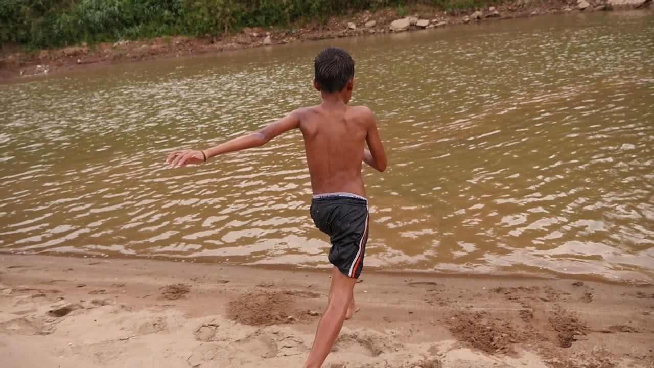 Boy Playing in the River