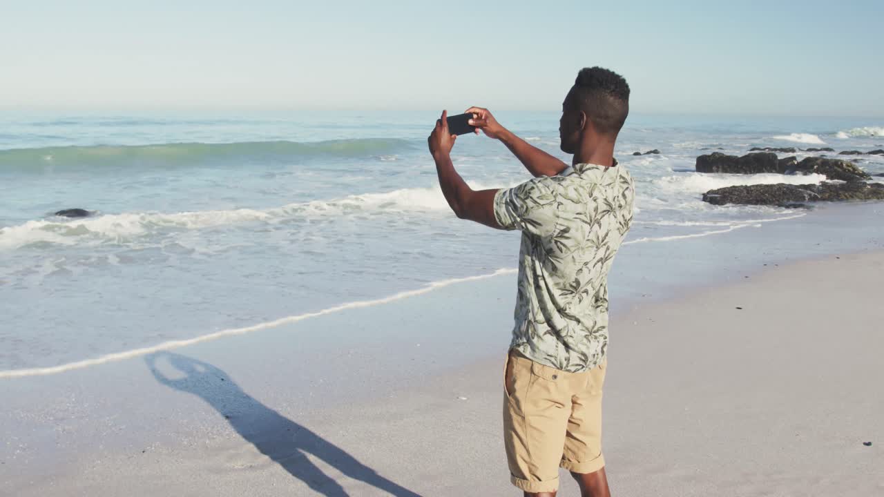 African American taking photo of the sea