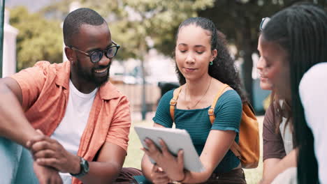 friends discussing on a tablet in a park