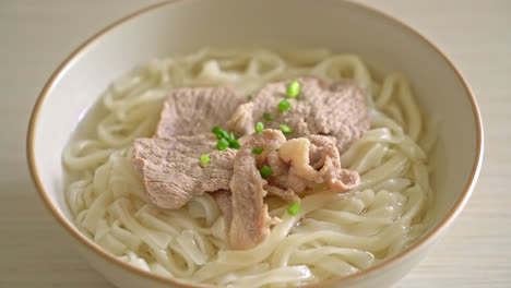 homemade udon ramen noodles with pork in clear soup