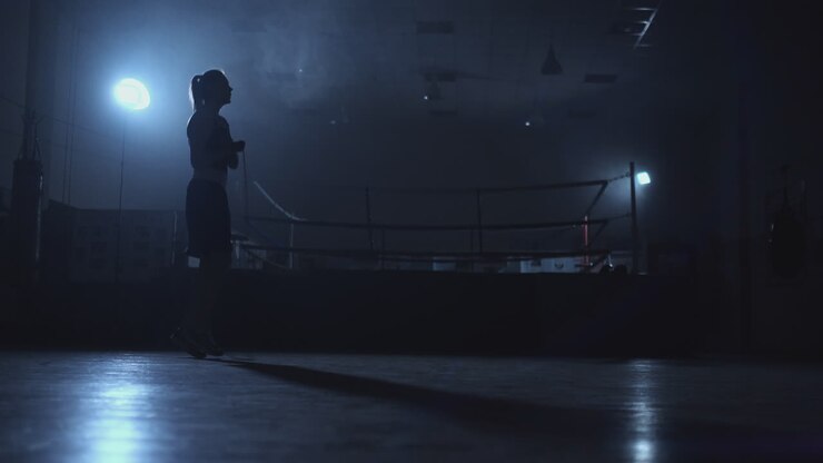 General plan of the gym Boxing gym with a ring and a young beautiful girl jumping rope