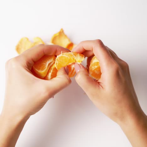 peeled mandarin in female hands