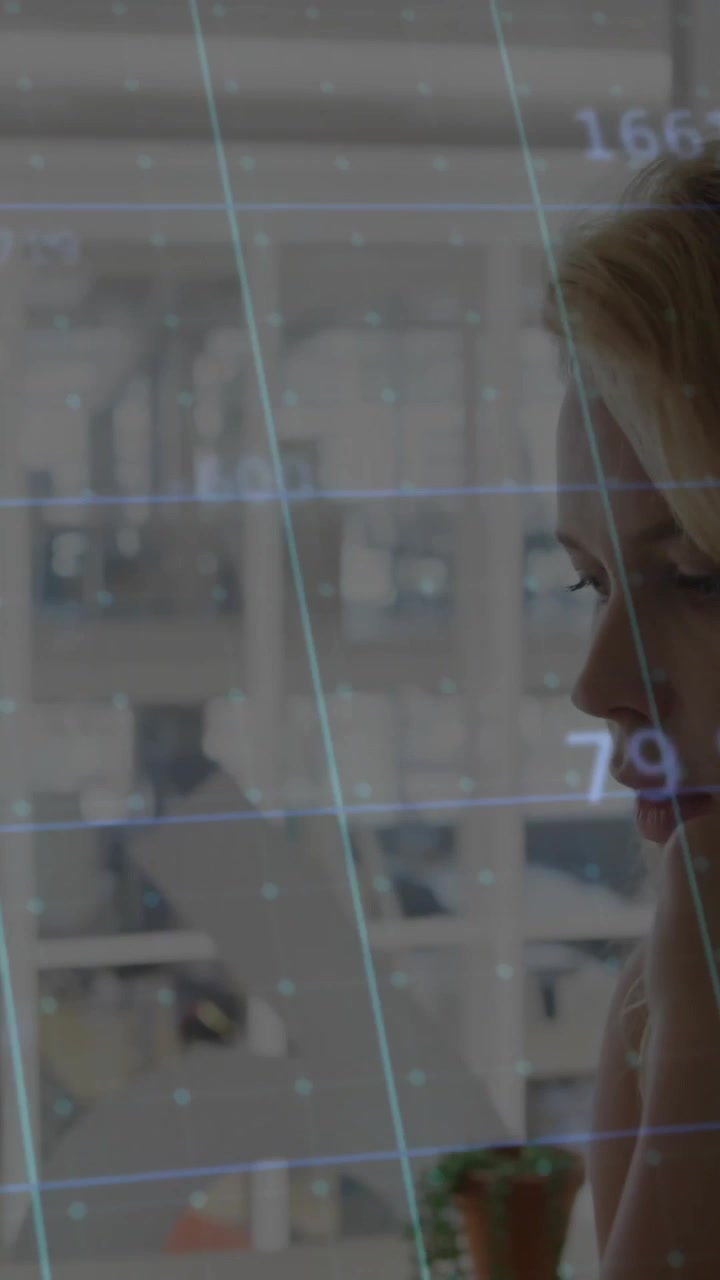 In office, woman analyzing data with animated graphics on computer screen