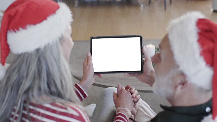Happy caucasian senior couple having christmas tablet video call with copy space, slow motion