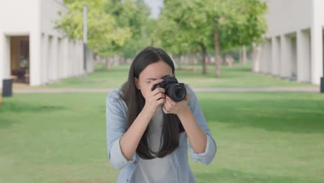 indian girl clicking photos using a camera