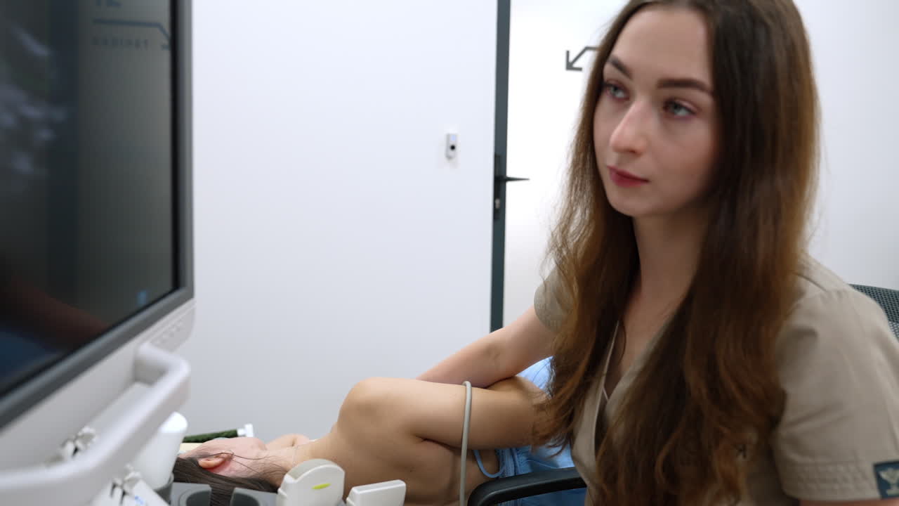 Kyiv, Ukraine, 2 August 2025: Ultrasound scan of female chest. Doctor performs transthoracic echocardiography with probe on woman side in exam room