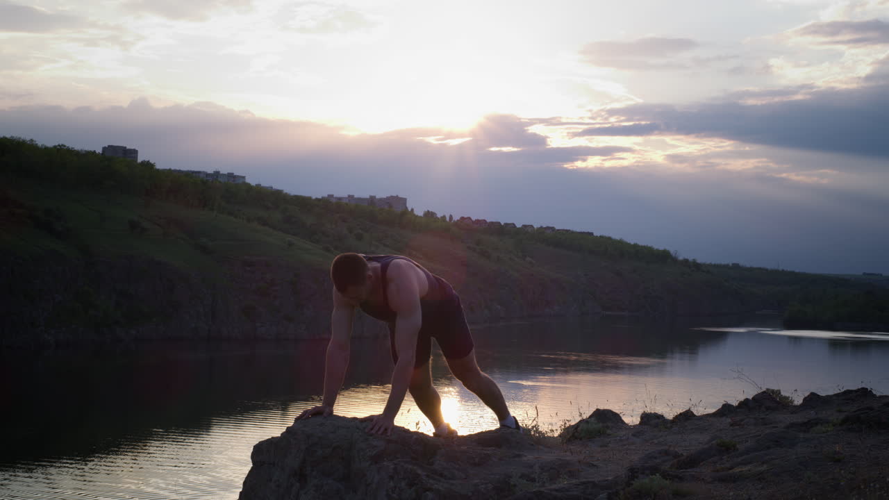 Man Exercising by the Lake at Sunset