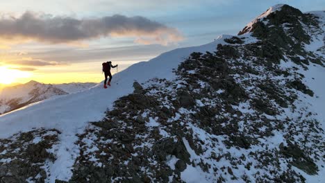 person with ski boots walks on a ridge in south tyrol