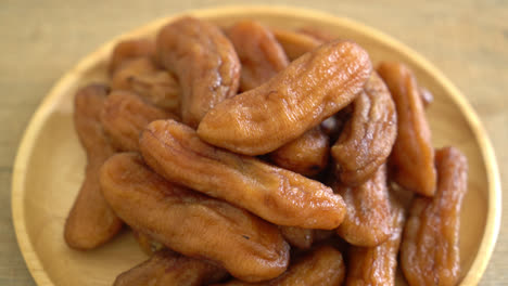 sun dried banana on wooden plate