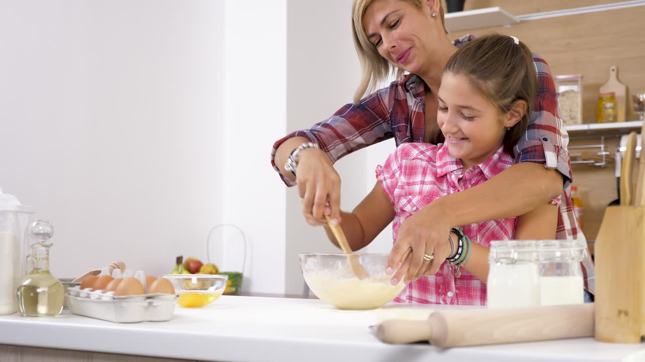 Mother and Daughter Baking Together in the Kitchen