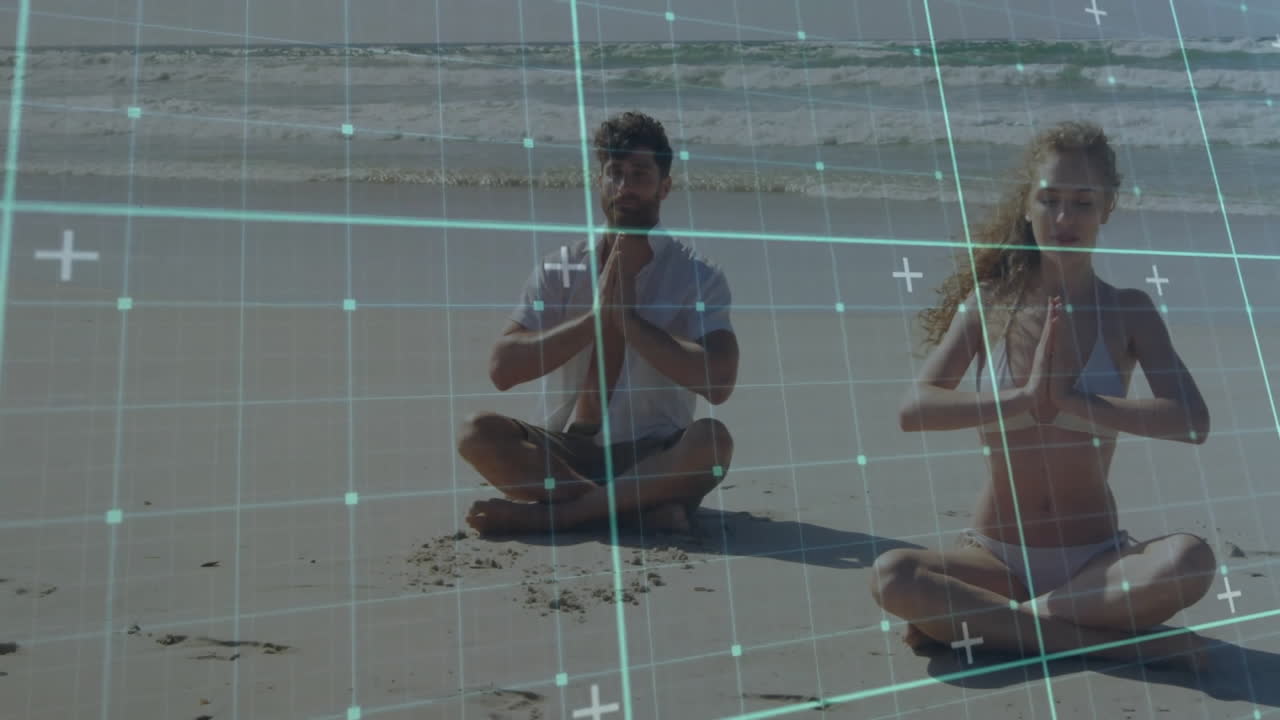 People meditating on beach with digital grid animation overlaying scene