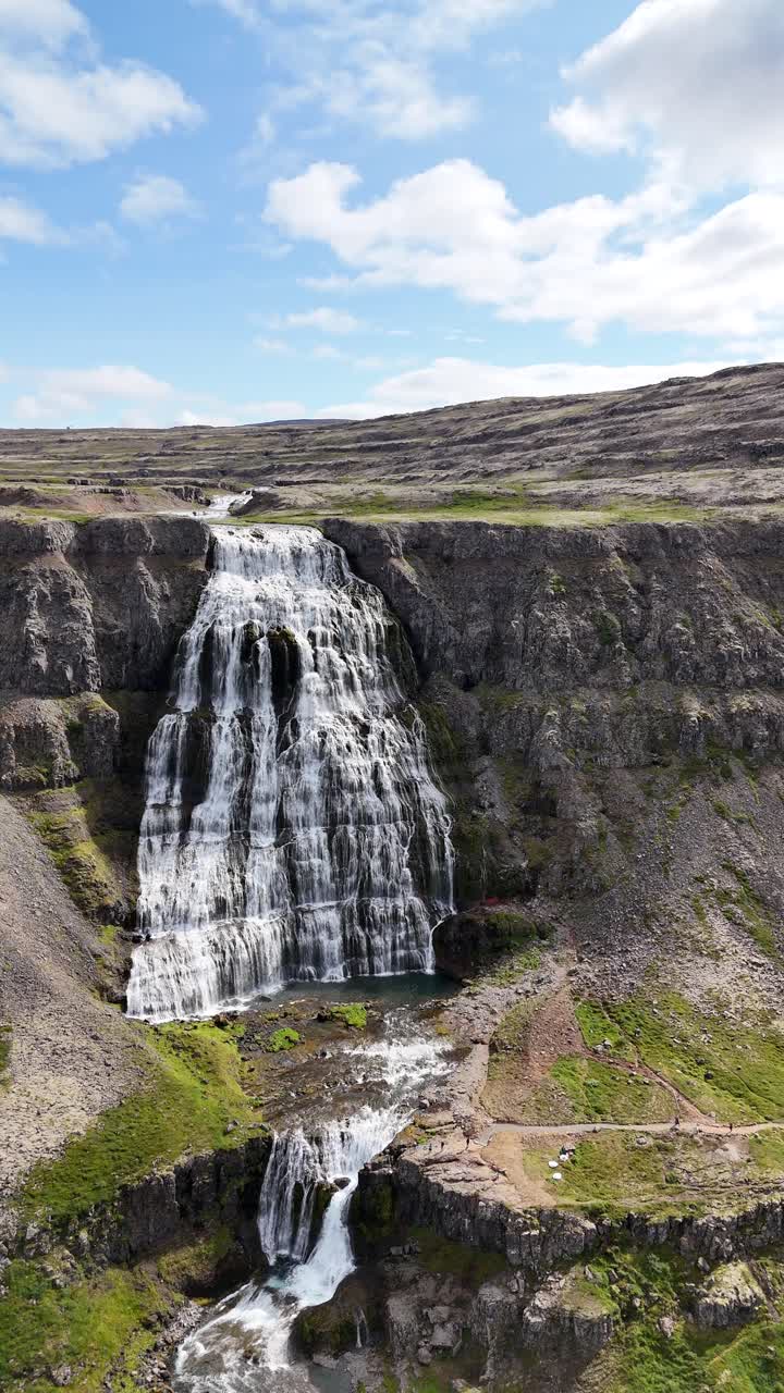 Aerial view of the breathtaking Hrisvaosfoss waterfall in Iceland, vertical video wide panning shot.