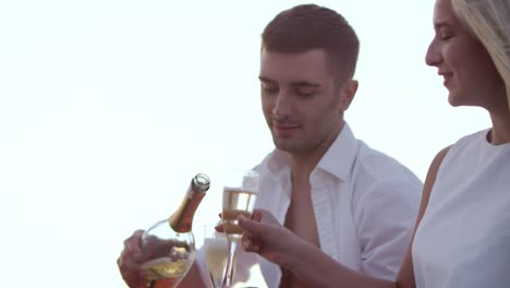 cute young couple drinking wine at sunset. boyfriend and girlfriend in love