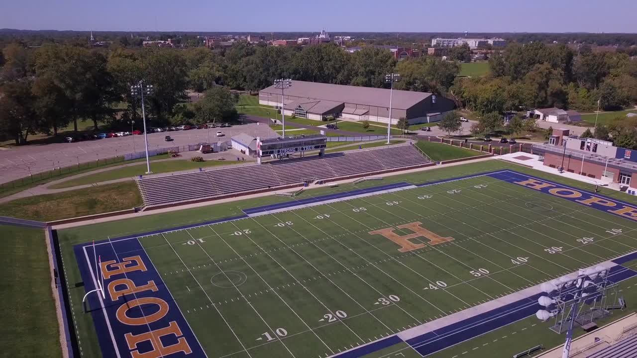 Aerial push-out of football field at Hope College in Michigan, USA