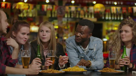 people men leisure friendship and technology concept - happy male friends drinking beer and taking selfie with smartphone at bar or pub