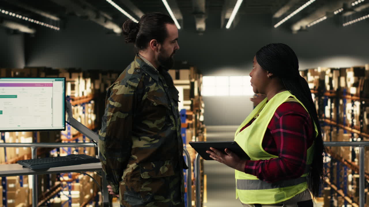Warehouse Workers Discussing Inventory Management on Tablet and Computer