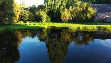 Swimming-place-of-Dzirnavu-lake-in-Blome,-Smiltene-district,-drone-view-on-sunny-summer-day