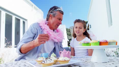 Smiling-father-and-daughter-in-fairy-costume-having-a-tea-party-4k