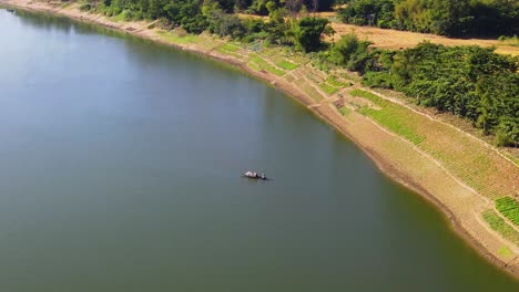 Wooden-fisherman-boat-in-vast-river-of-Surma,-Bangladesh