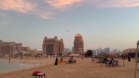 plane in the sky, sunset time and sky in colorful, world cup countries' flags are seen on the roof of building