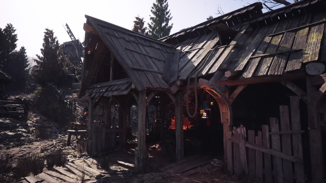 un pueblo medieval con una casa de madera, un molino de viento y una pared de piedra