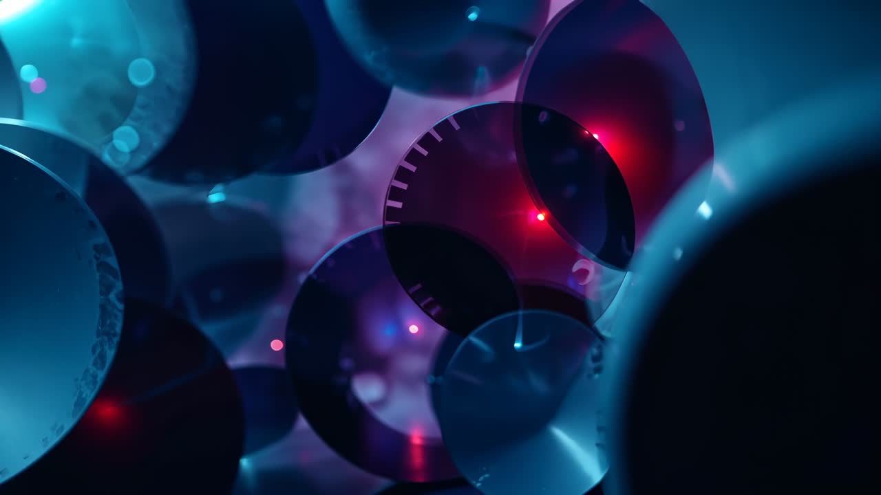 At start camera panning across cluster of metallic discs in studio, revealing color reflections